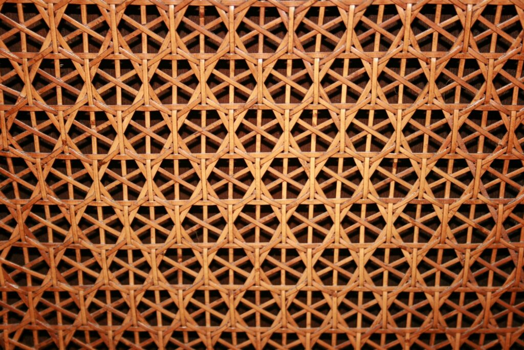 Close-up of a woven cane pattern showcasing intricate geometric design and natural texture.
